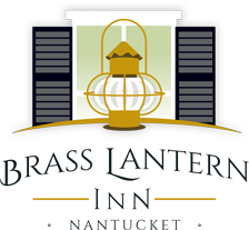 Logo - Illustration of Brass Lantern in front of white window with black shutters with the text below BRASS LANTERN INN NANTUCKET