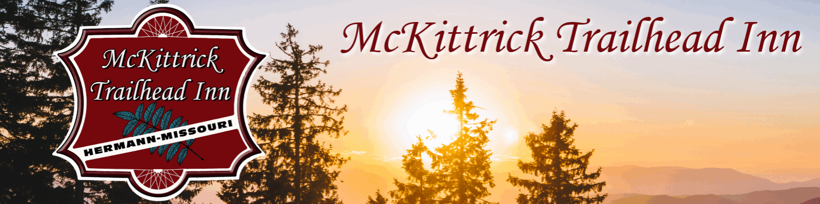 sunset over the pine trees behind the McKittrick Trailhead Inn logo